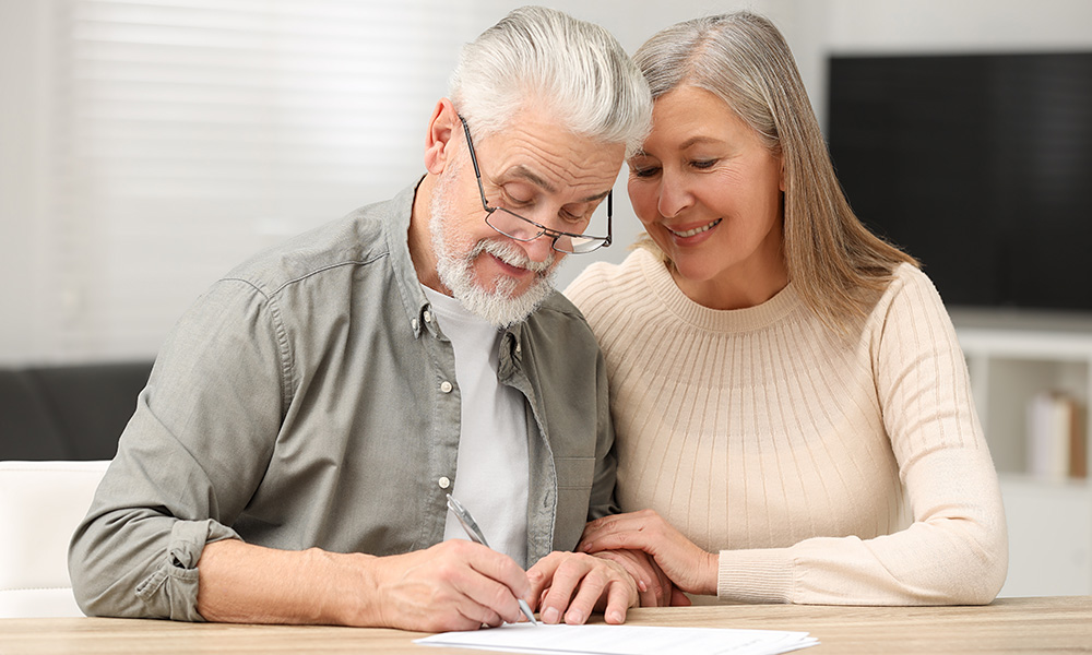 Coppia di anziani che firmano un documento